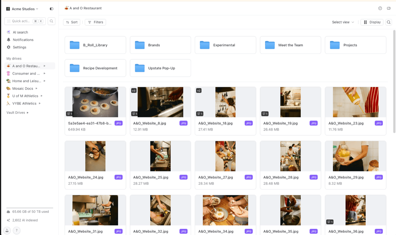 Shade web app showing a restaurant project drive's media library: folders like B_Roll_Library and Recipe Development above a grid of JPG thumbnails with file sizes, and the storage meter with an AI-indexed count of 2,602 files in the lower-left sidebar